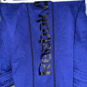 Blue with black logo Reebok track pants.
